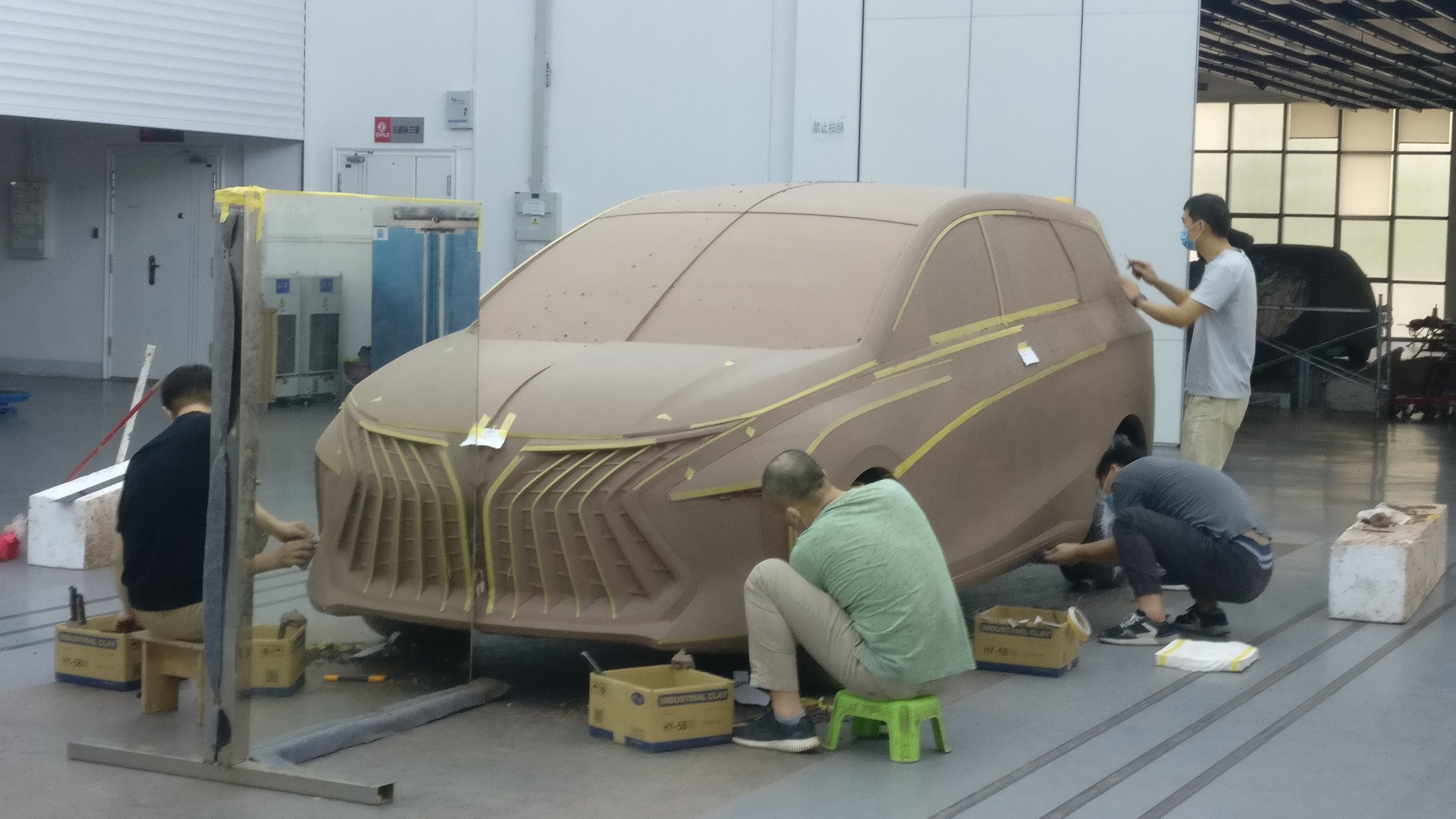 Team taping the full-size clay