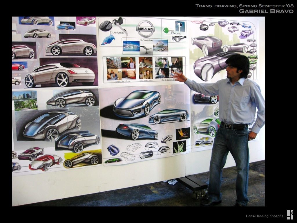 A student presenting his semester wall of car sketches